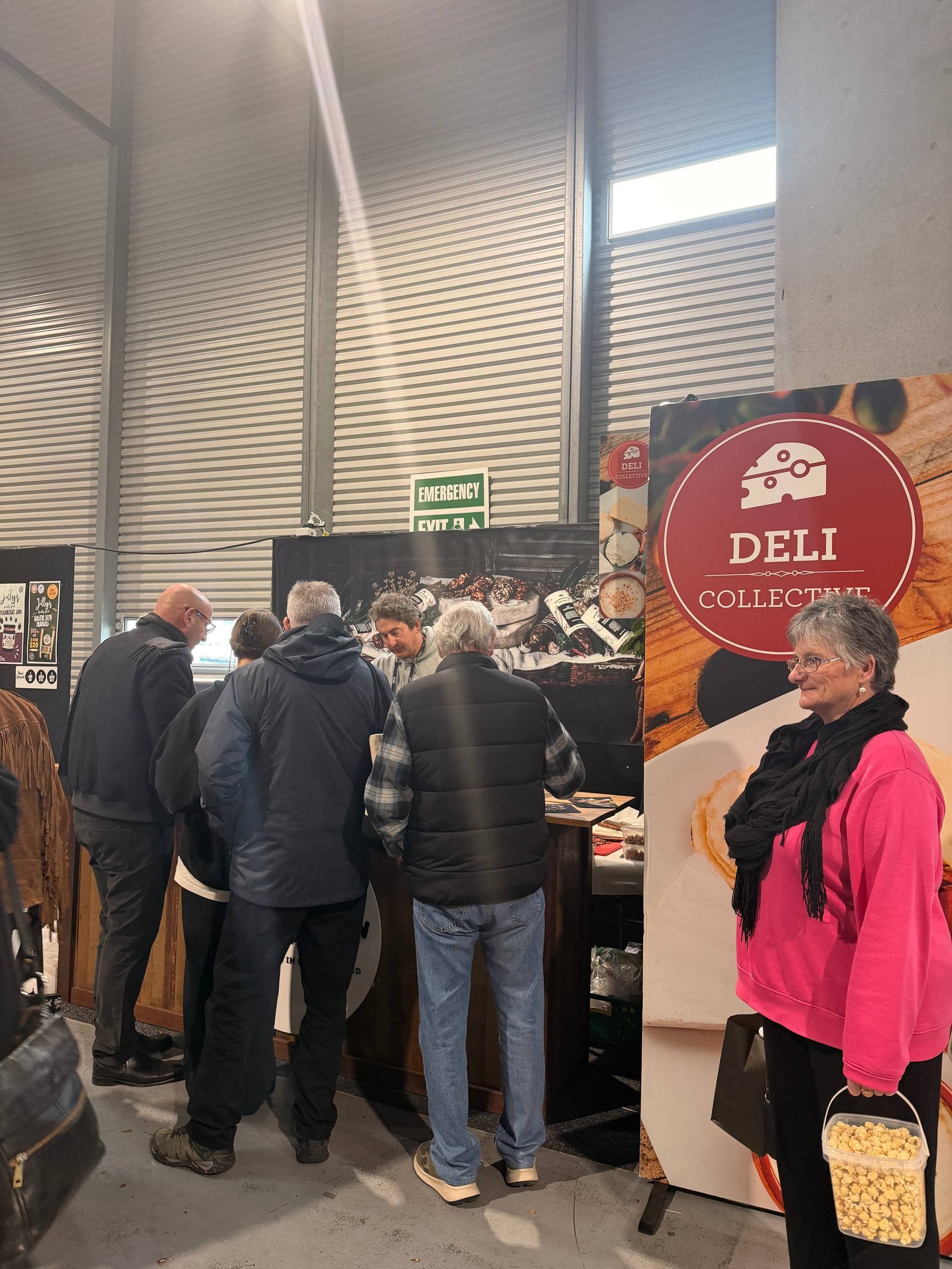 Visitors at the Deli Collective stand
